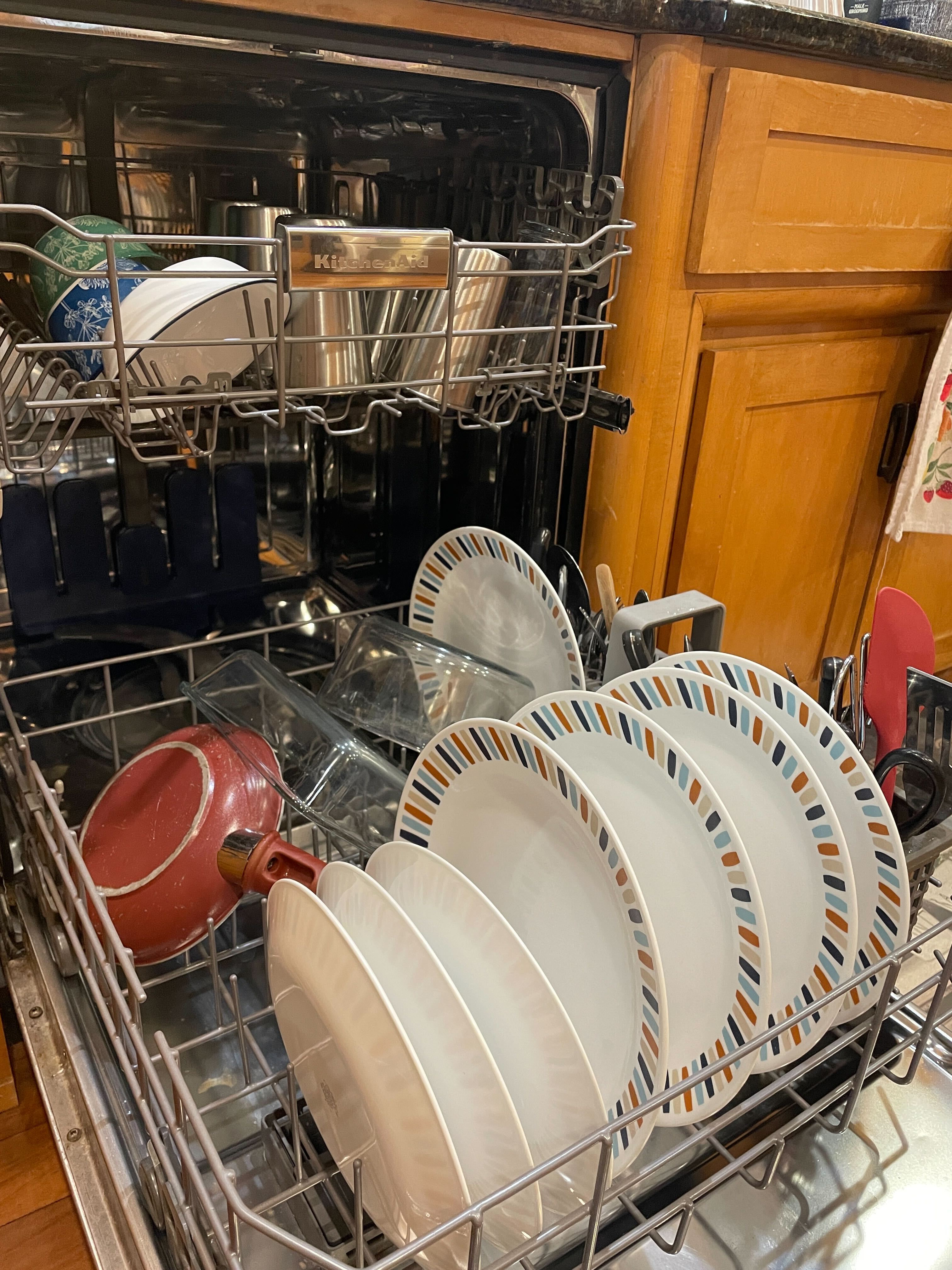 Spotless dishes inside dishwasher cleaned with Dishwasher Sheets, a safe, plant-based natural cleaning product for eco-friendly dishwashing.