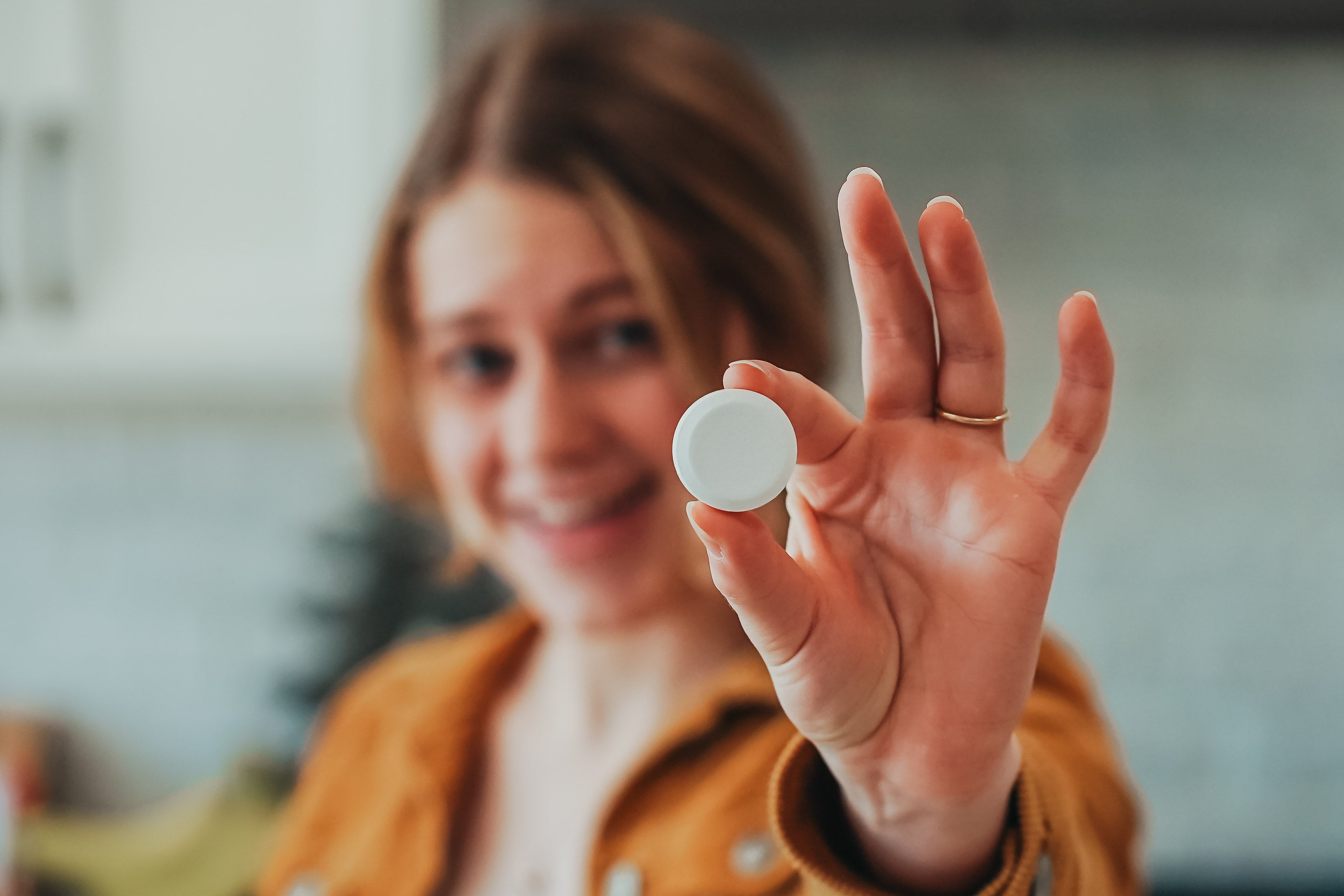 Woman holding a Cleaning Bomb, part of a natural cleaning product and bathroom cleaner bomb, safe, eco-friendly, and effective toilet cleaner bomb solution for home cleaning.